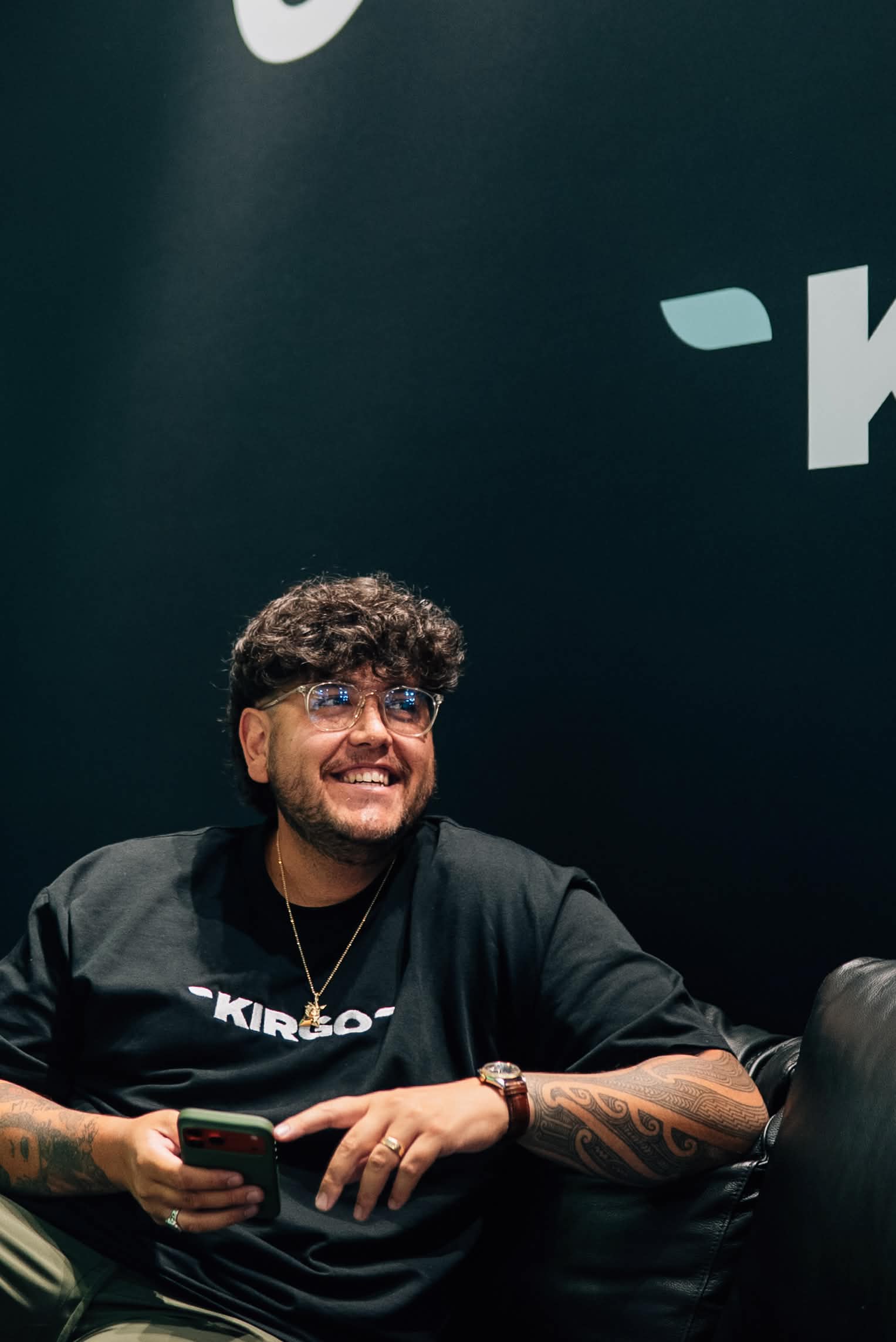 Aiden seated in front of Kirgo branded wall